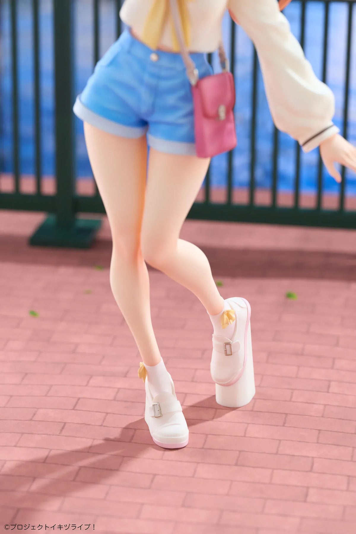 Polka Takahashi 1/7 scale figure with orange hair, a white sailor-style top, blue shorts, and a pink shoulder bag, posed on a yellow base.