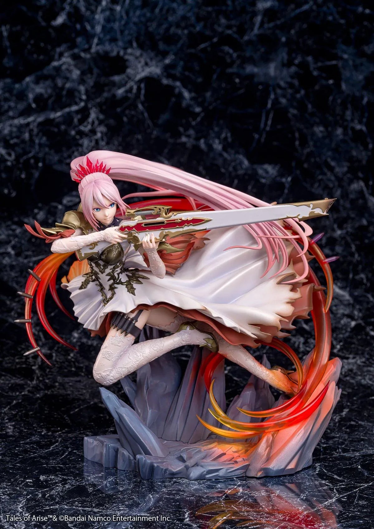 Tales of Arise Shionne 1/7 Scale Figure featuring a pink-haired anime character with blue eyes, an ornate white battle dress, gold armor, and lace stockings, aiming a detailed rifle while suspended in a dynamic pose surrounded by translucent red and orange effects on a rocky display base.