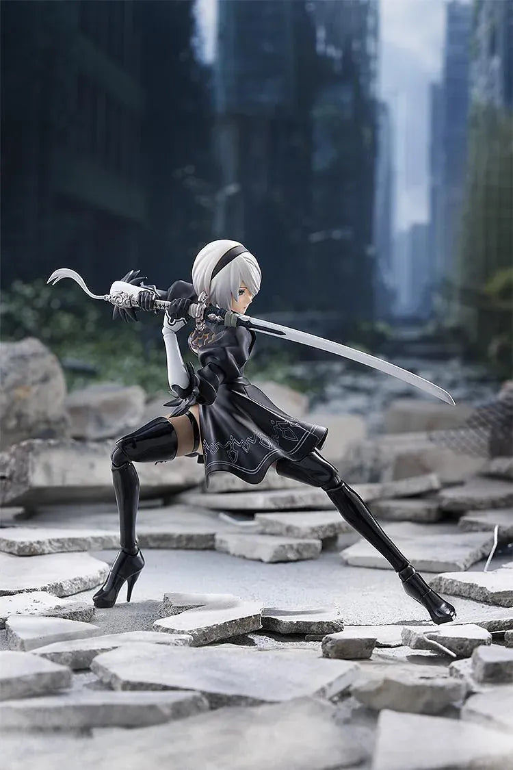 NieR Ver1.1a figma 2B figure with silver hair, a black visor, patterned black outfit, white sleeves, glossy boots, and a support robot.