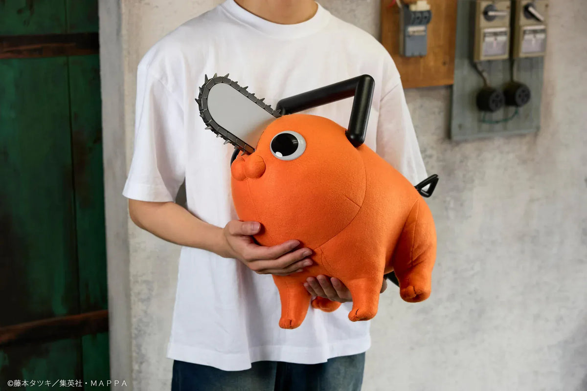 Chainsaw Man life-size Pochita doll figure with an orange body, glossy eyes, chainsaw blade, black handle, and pull cord.
