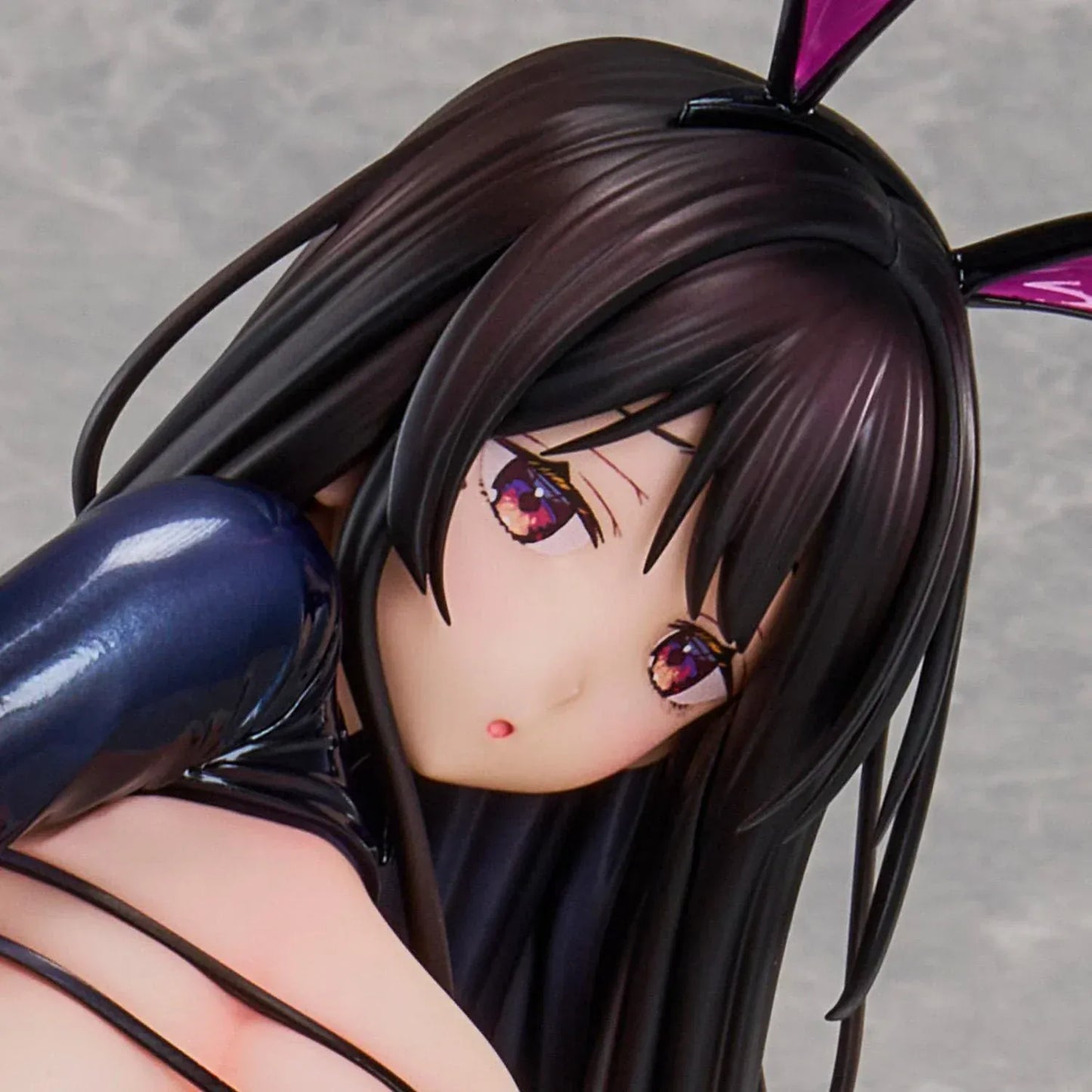 Reverse Bunny anime figure based on a Hirari illustration, posed low to the ground in a glossy dark bunny suit with long flowing hair and pink heels.