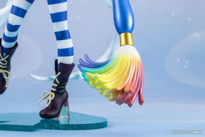 Amulet Spade 1/7 scale figure with pink hair, a white-and-blue costume, striped stockings, and an oversized rainbow-tipped paintbrush.