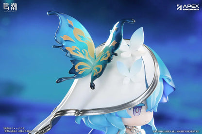 Chibi Shorekeeper Jinseki Series figure with blue hair, a butterfly-decorated headpiece, and a blue butterfly held in her hands, standing on a water-inspired base.