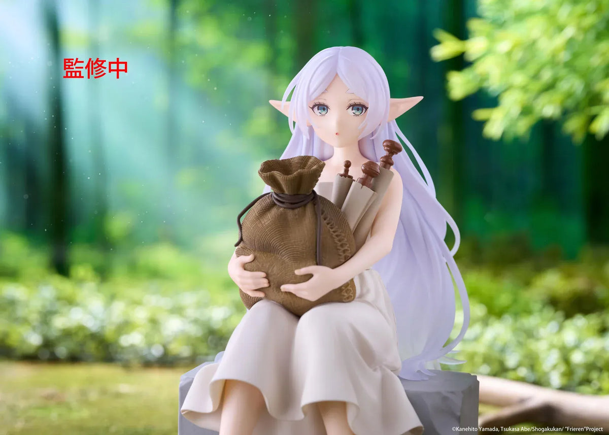 Desktop Cute Frieren In Training Ver. figure seated on a gray stone block, wearing a cream dress and brown sandals while holding a sack beside rolled scrolls.