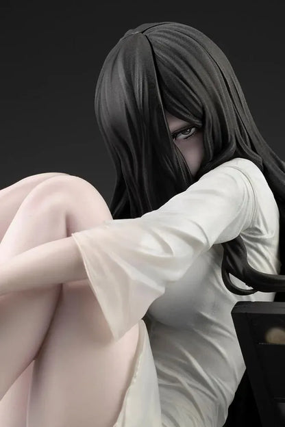 Sadako BISHOUJO Sadako 1/7 Scale Figure (Rerelease) featuring a long black-haired horror character wearing a flowing white dress, seated above a pile of VHS tapes with tangled black film ribbons.