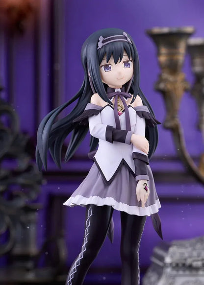 Homura Akemi figure with long black hair, violet eyes, a white and purple outfit, and diamond-patterned stockings, smiling with one hand resting on her arm.