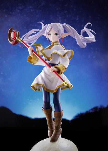 Frieren vs Aura 1/7 scale figure holding a red staff while wearing her white-and-gold mage outfit on a rounded display base.