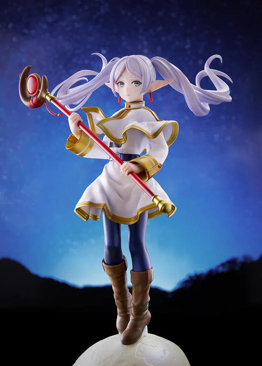 Frieren vs Aura 1/7 scale figure holding a red staff while wearing her white-and-gold mage outfit on a rounded display base.