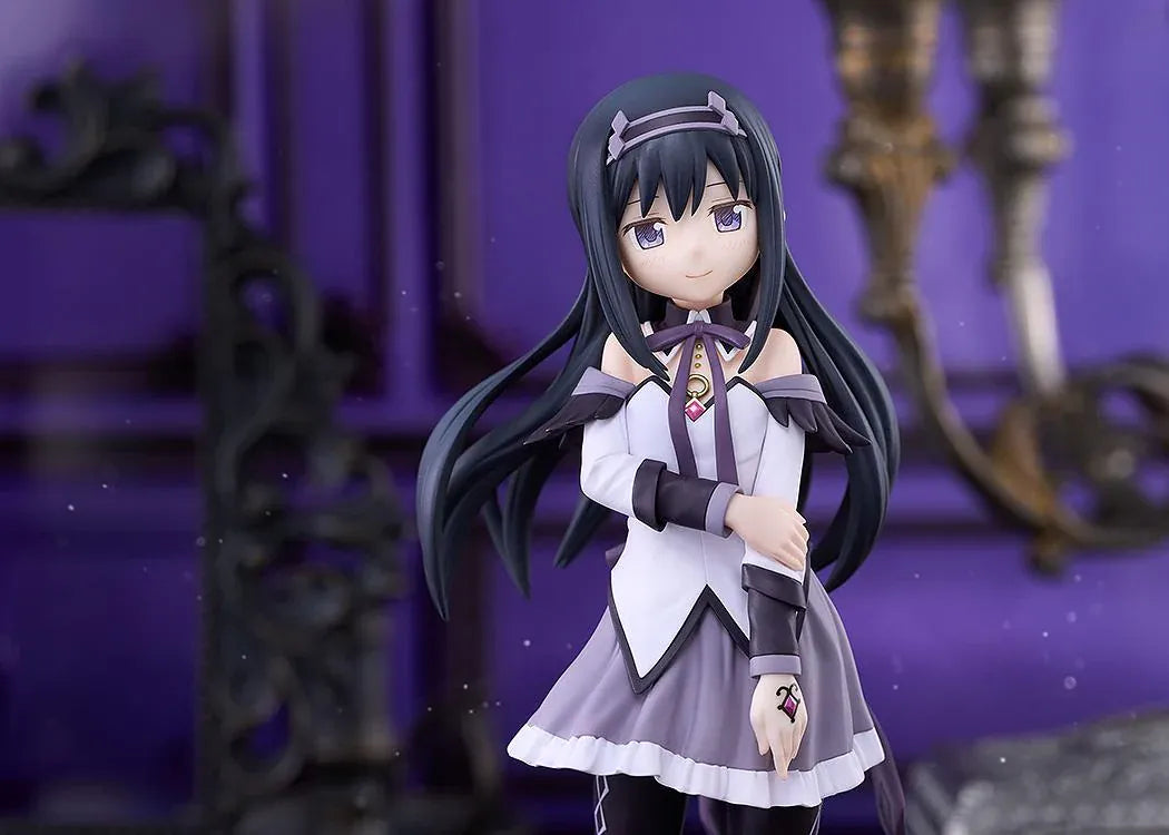 Homura Akemi figure with long black hair, violet eyes, a white and purple outfit, and diamond-patterned stockings, smiling with one hand resting on her arm.