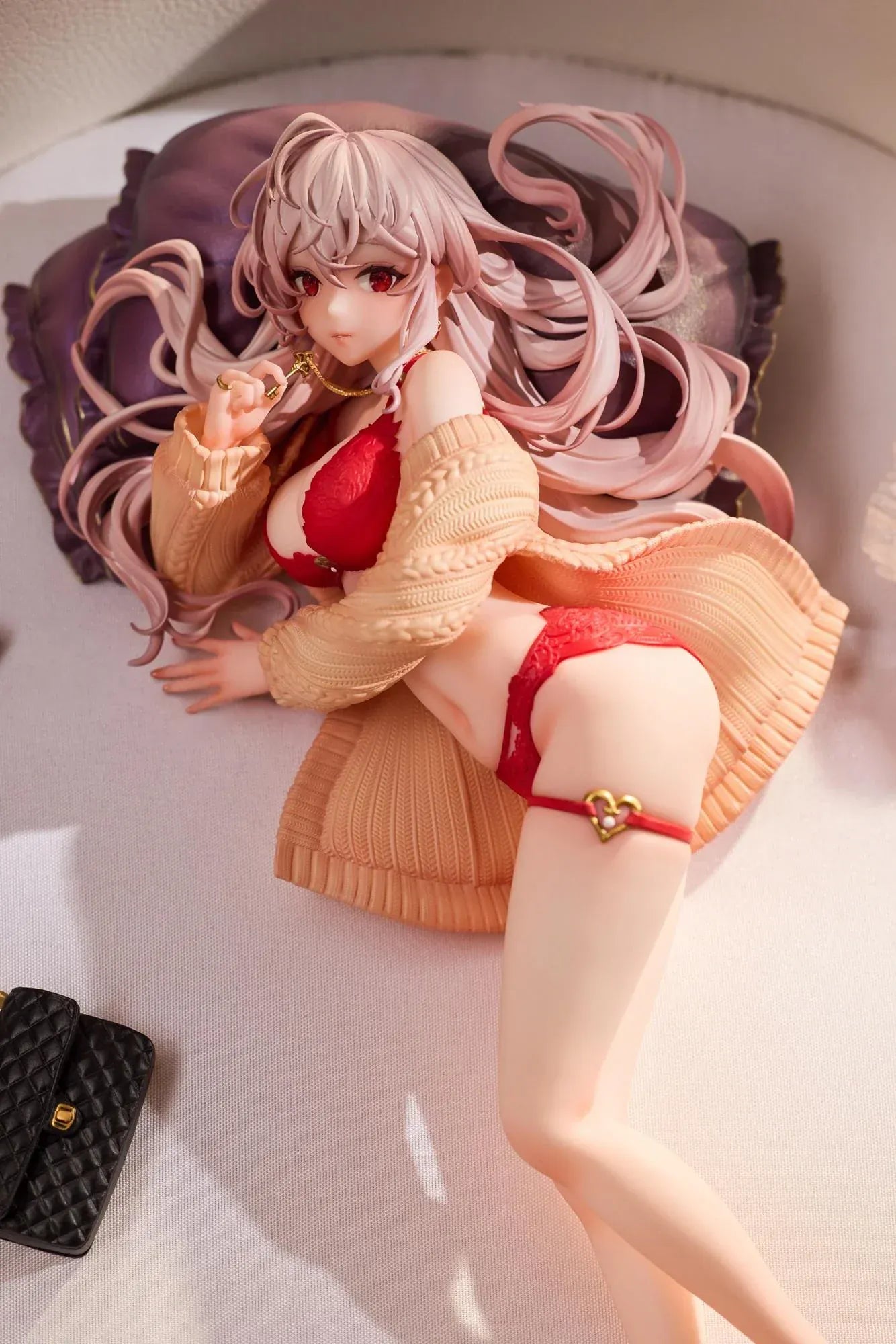 Makia 1/7 scale figure lying on a large fluffy white round base, wearing a cardigan and red lingerie, resting on a purple pillow