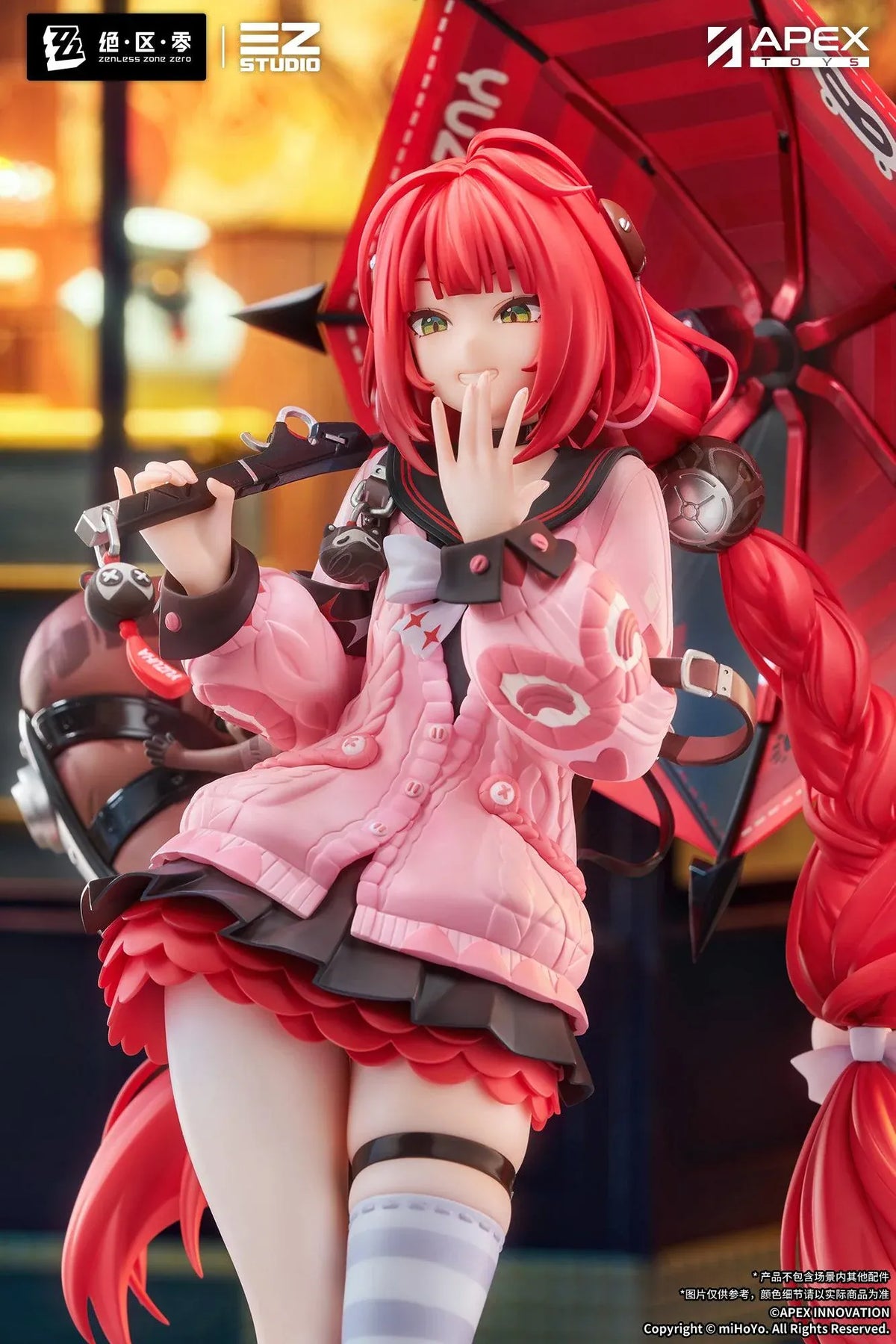Zenless Zone Zero Yuzuha Ukinami 1/7 Scale Figure by APEX Toys featuring a red-haired anime girl with long braided twin-tails, green eyes, a pink jacket, layered red skirt, striped thigh-high stockings, and black boots while holding a large red umbrella on a circular display base.