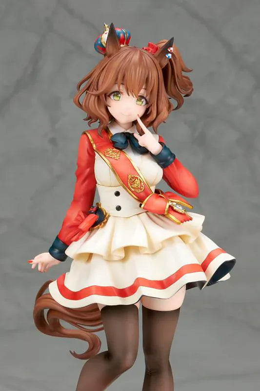 UmaMusume Pretty Derby Aston Machan 1/7 Scale Figure featuring Aston Machan with horse ears, short brown hair, red-and-cream outfit, plush doll accessory, and themed display base.