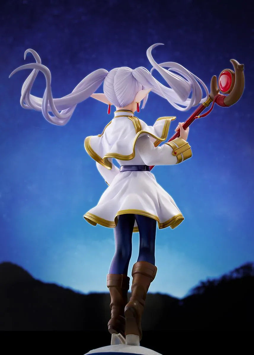 Frieren vs Aura 1/7 scale figure holding a red staff while wearing her white-and-gold mage outfit on a rounded display base.