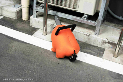 Chainsaw Man life-size Pochita doll figure with an orange body, glossy eyes, chainsaw blade, black handle, and pull cord.