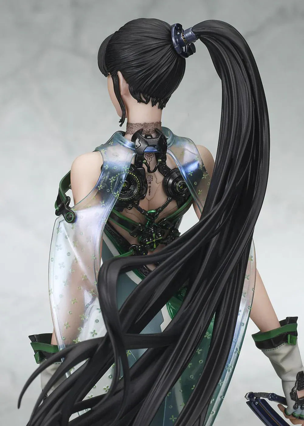 Stellar Blade Eve non-scale figure in a futuristic green and gray combat suit holding a long sword with flowing black hair