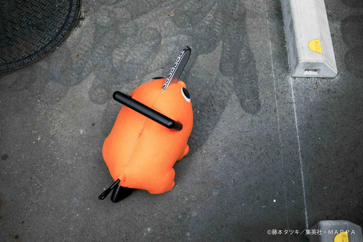Chainsaw Man life-size Pochita doll figure with an orange body, glossy eyes, chainsaw blade, black handle, and pull cord.