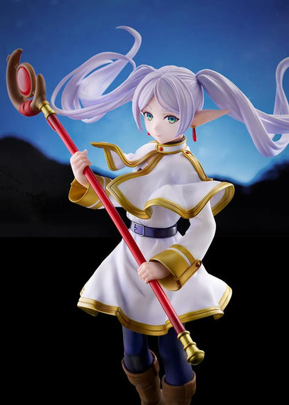 Frieren vs Aura 1/7 scale figure holding a red staff while wearing her white-and-gold mage outfit on a rounded display base.