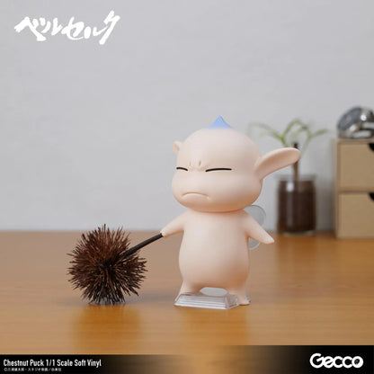 Berserk Chestnut Puck 1/1 Scale Soft Vinyl Figure by Gecco featuring a small cream-colored elf with oversized pointed ears, a tiny blue hair tuft, closed eyes, a grumpy expression, and a rounded body holding a large spiky brown chestnut burr.