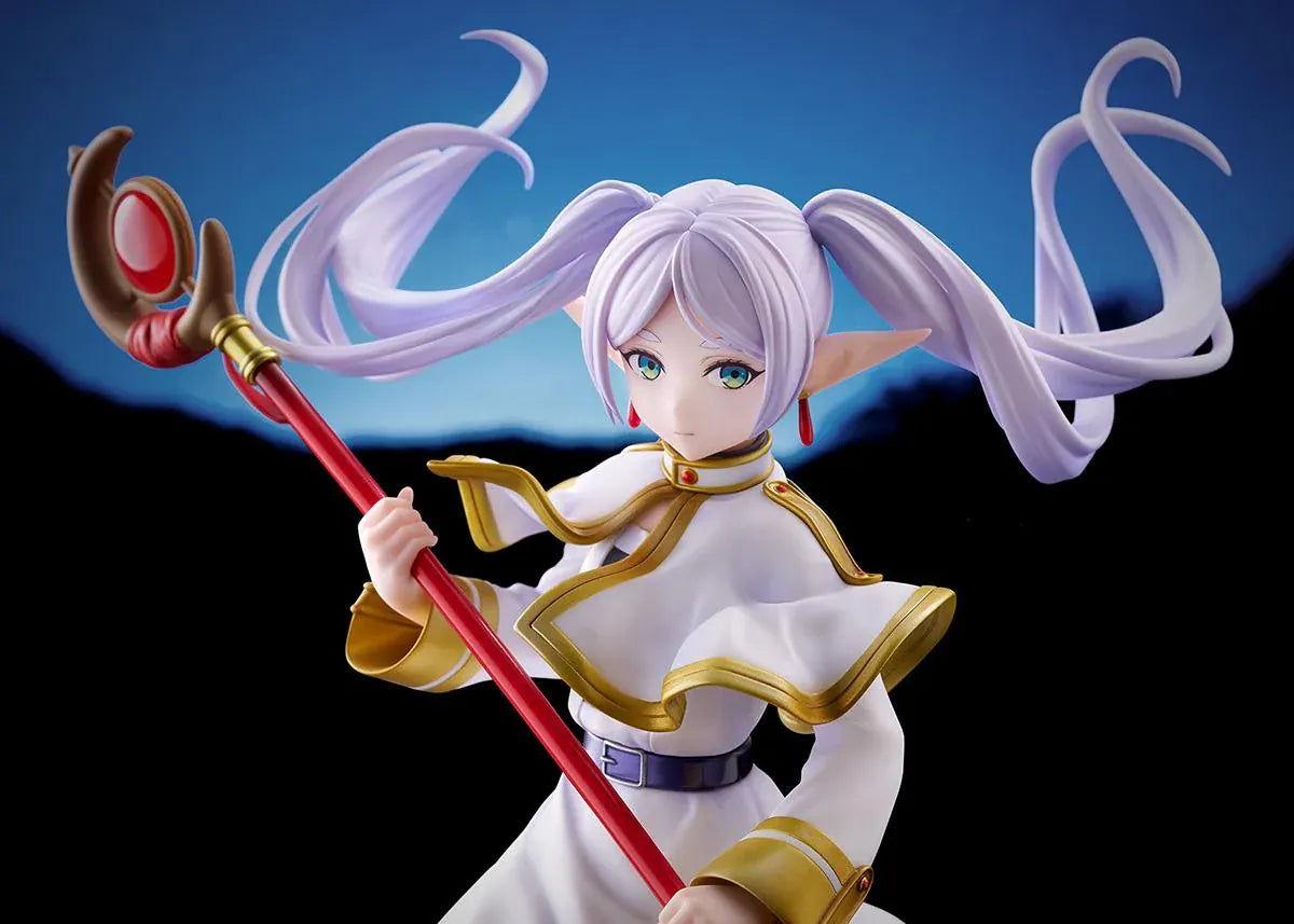 Frieren vs Aura 1/7 scale figure holding a red staff while wearing her white-and-gold mage outfit on a rounded display base.