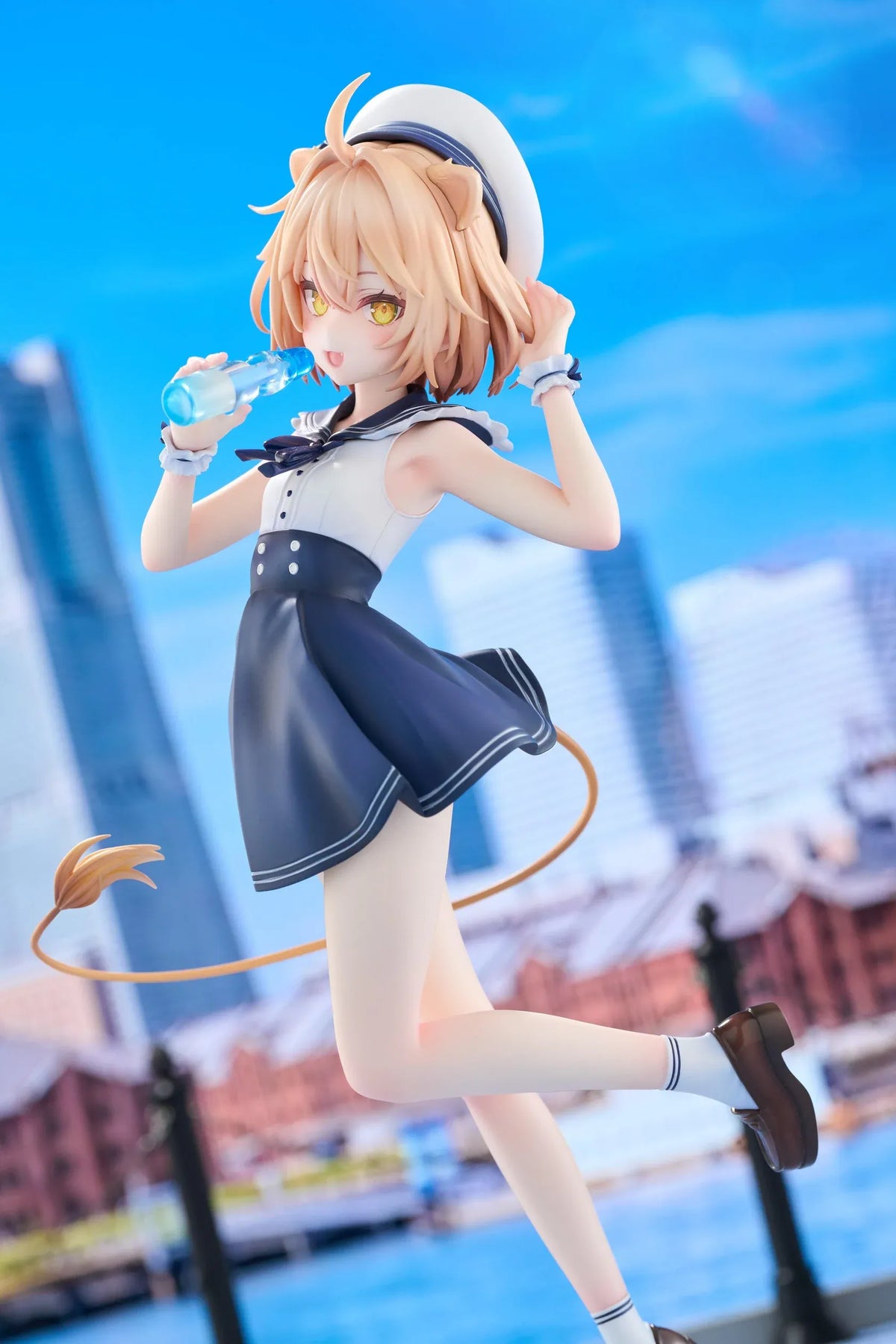 Rurudo Lion Marine Sailor Ver. figure in a navy and white sailor dress and hat, holding a blue bottle beside a chibi lion companion.