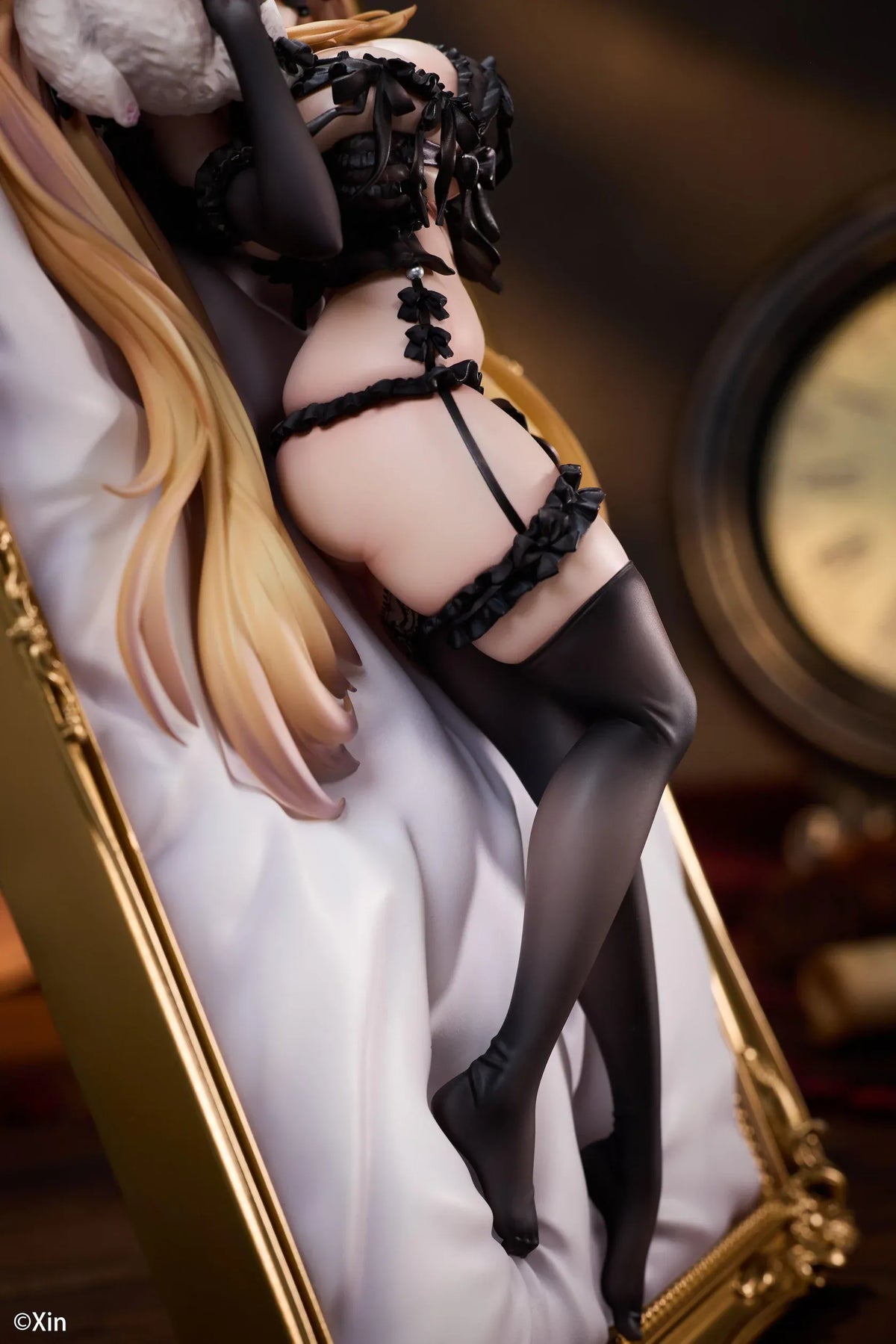 Stella Black Cat Ver. Deluxe Edition 1/7 Scale Figure illustrated by Xin, featuring a blonde-haired catgirl with red eyes, black lace lingerie, cat ears, and thigh-high stockings displayed in an ornate golden frame with a matching illustrated wall scroll.