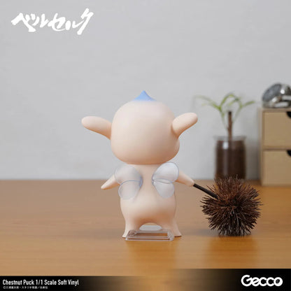 Berserk Chestnut Puck 1/1 Scale Soft Vinyl Figure by Gecco featuring a small cream-colored elf with oversized pointed ears, a tiny blue hair tuft, closed eyes, a grumpy expression, and a rounded body holding a large spiky brown chestnut burr.