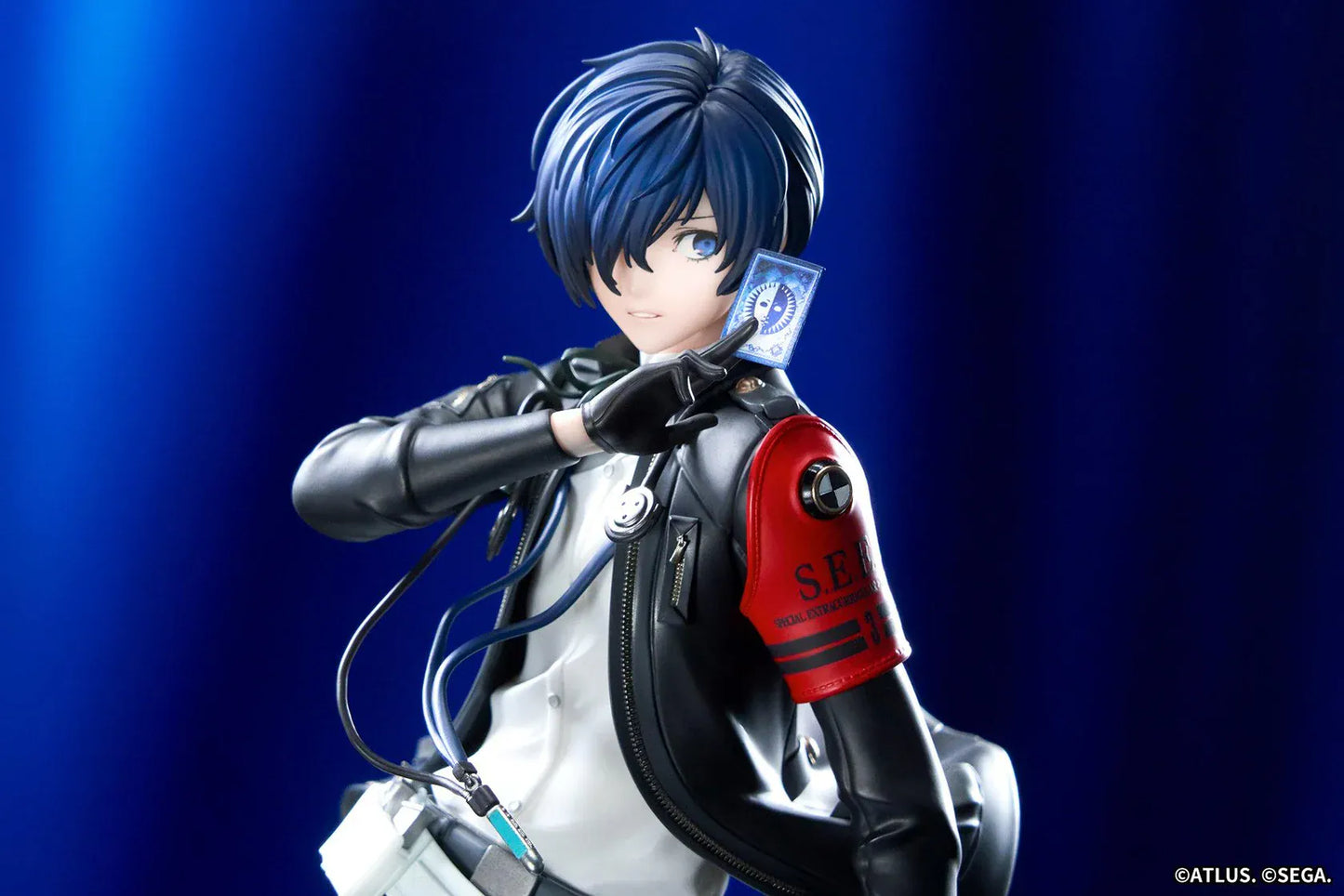 Persona 3 Reload Limepie Protagonist 1/8 Scale Figure with blue hair, black jacket, S.E.E.S. armband, headphones, and themed display base