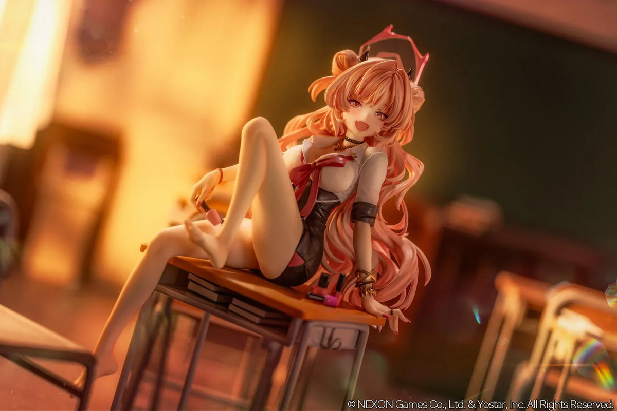 Blue Archive Kirara figure with long pink hair, black horns, and a pink halo, seated on a classroom desk beside nail polish bottles.