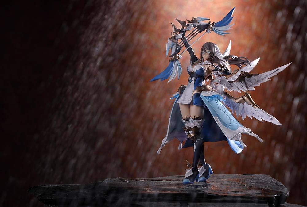 Assembled Arcanadea Ermeda model kit with long brown hair, white feathered wings, a blue and white outfit, gold armor accents, and armored boots.