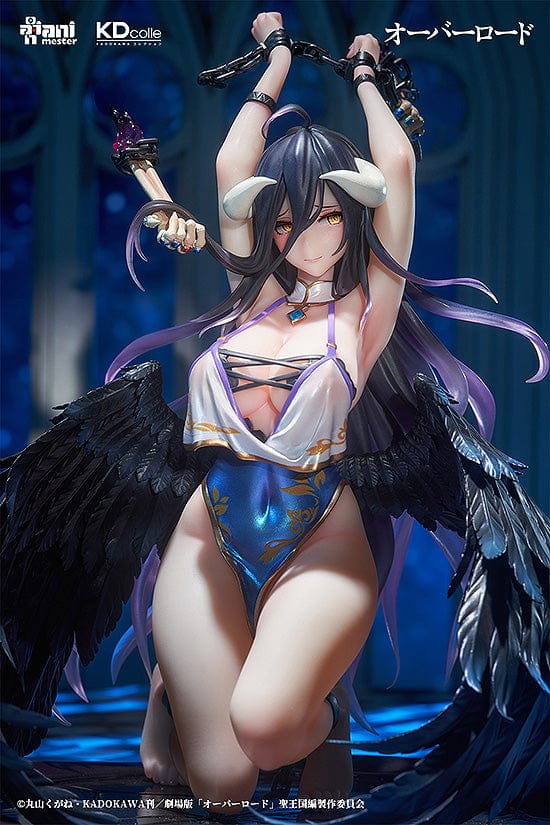 "Collectible figure of Albedo in a 'Restrained Version' pose with raised arms holding chains, adorned with black raven wings, wearing a blue and white costume with ornamental details, and sitting atop a circular base with decorative elements."