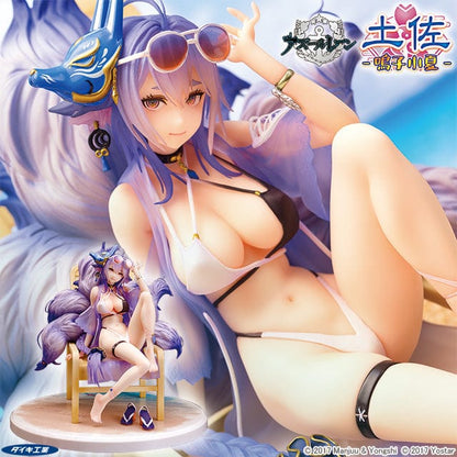 A 1/7 scale figure of Azur Lane's Tosa in the 'Hometown Zest Ver.', reclining on a wooden deck chair with her legs crossed. She dons a purple bikini and matching flip-flops, with a large flowing mane of blue-grey hair and sunglasses perched on her head. The base resembles a sandy beach, complete with the inscription 'AZUR LANE' as if written in the sand.