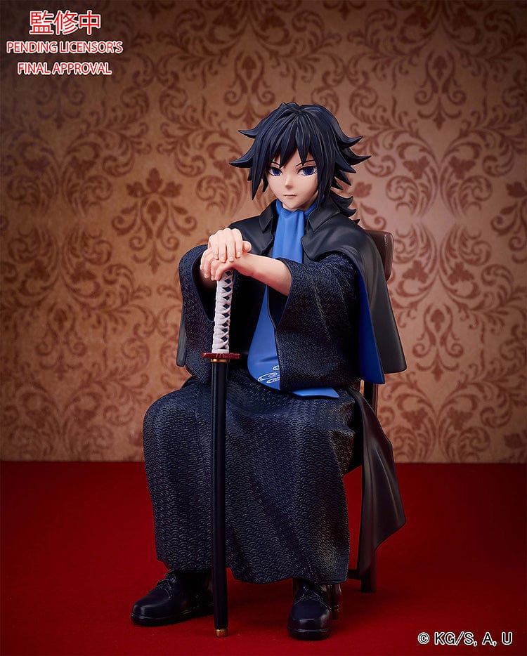 Demon Slayer: Kimetsu no Yaiba Giyu Tomioka figure seated with sheathed sword, wearing black and blue haori, showing calm and serious expression.