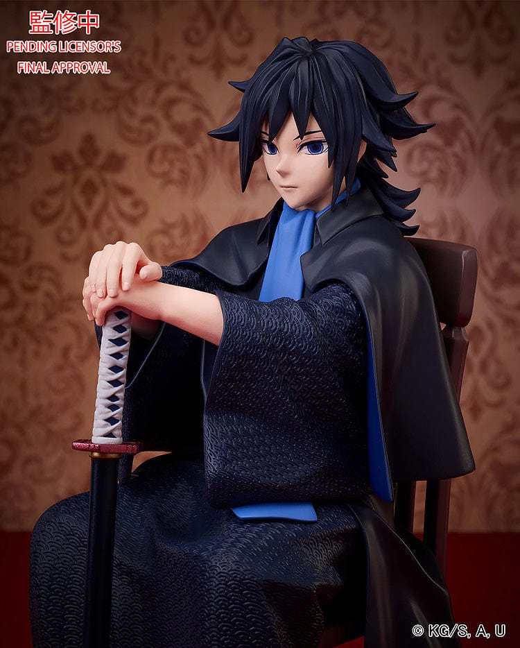 Demon Slayer: Kimetsu no Yaiba Giyu Tomioka figure seated with sheathed sword, wearing black and blue haori, showing calm and serious expression.