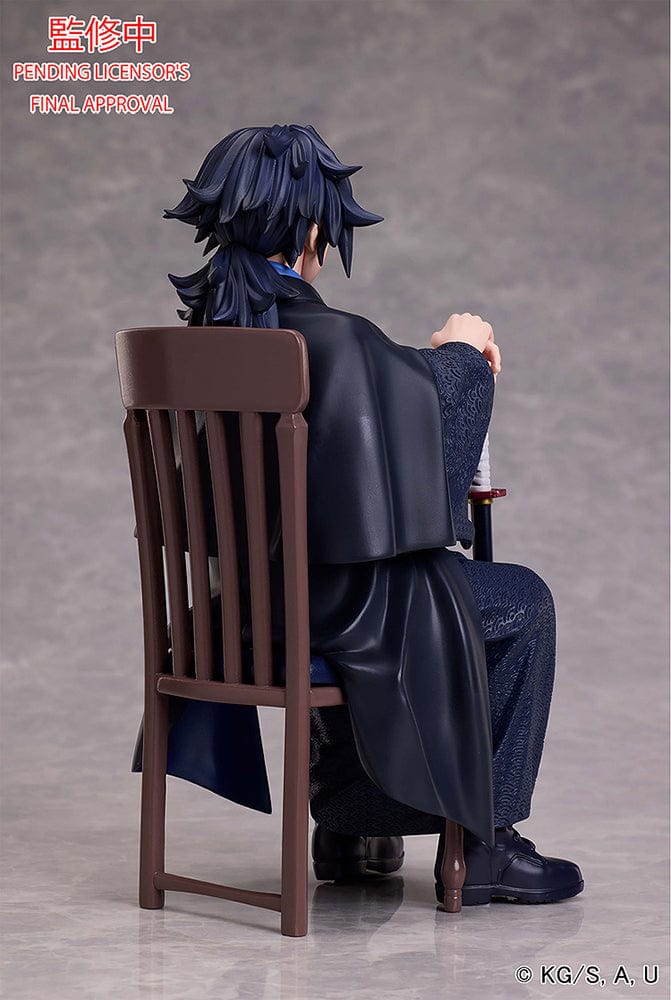 Demon Slayer: Kimetsu no Yaiba Giyu Tomioka figure seated with sheathed sword, wearing black and blue haori, showing calm and serious expression.