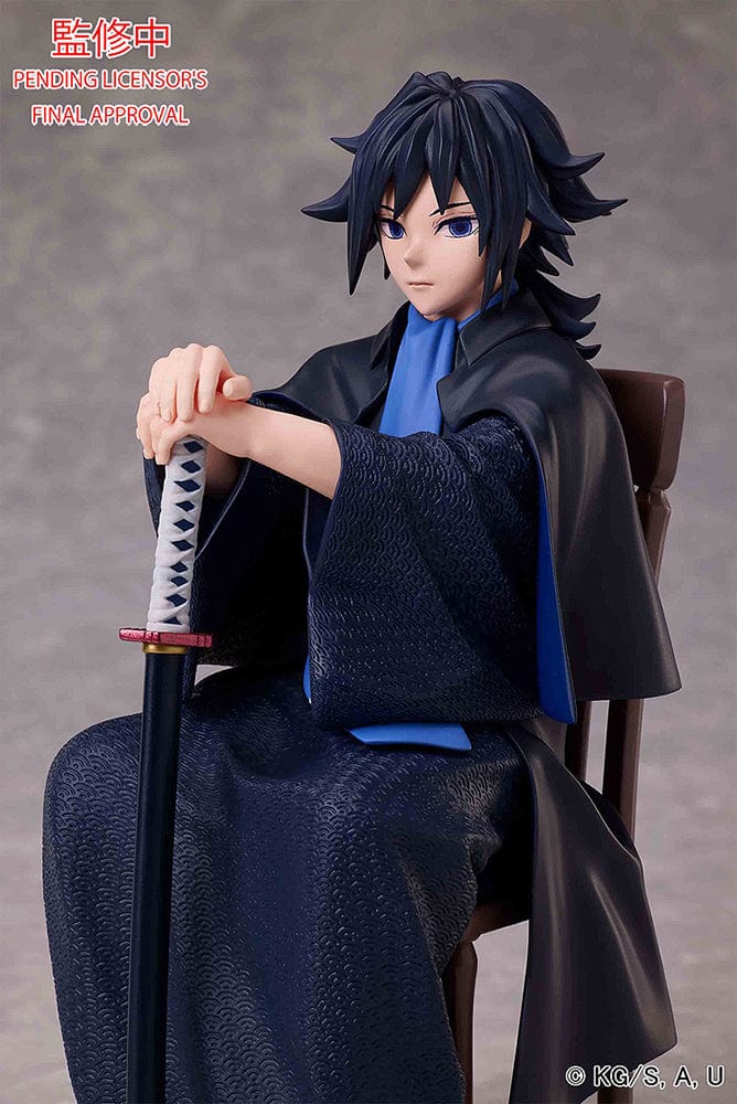 Demon Slayer: Kimetsu no Yaiba Giyu Tomioka figure seated with sheathed sword, wearing black and blue haori, showing calm and serious expression.