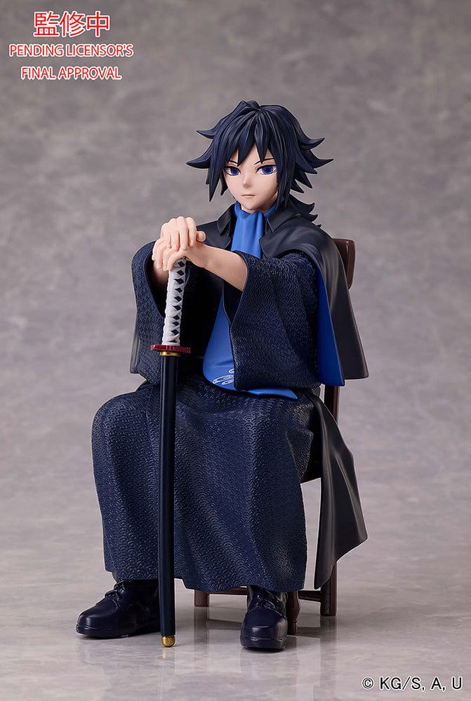 Demon Slayer: Kimetsu no Yaiba Giyu Tomioka figure seated with sheathed sword, wearing black and blue haori, showing calm and serious expression.