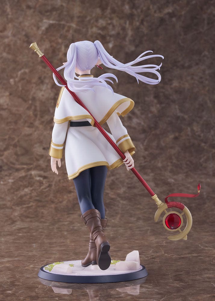 Frieren: Beyond Journey's End Frieren 1/7 Scale Figure, presenting the ageless mage in her white and gold-trimmed robe, holding her red and gold staff, with a serene expression that conveys wisdom and an air of mystique