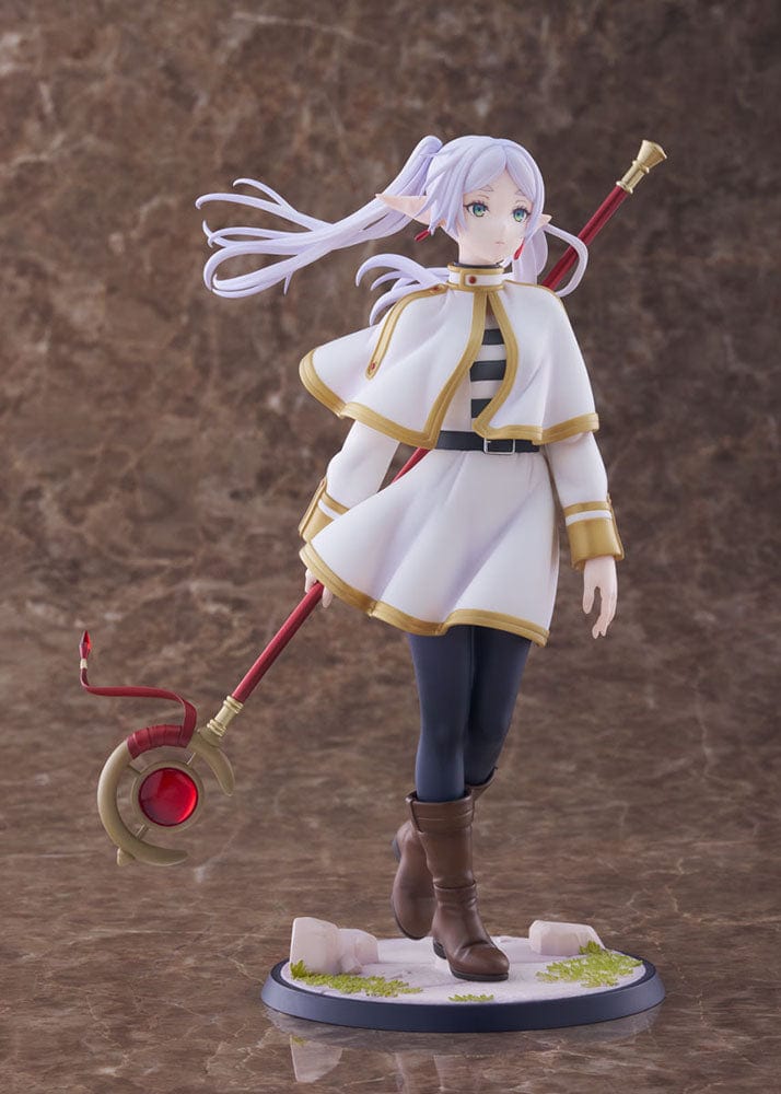 Frieren: Beyond Journey's End Frieren 1/7 Scale Figure, presenting the ageless mage in her white and gold-trimmed robe, holding her red and gold staff, with a serene expression that conveys wisdom and an air of mystique