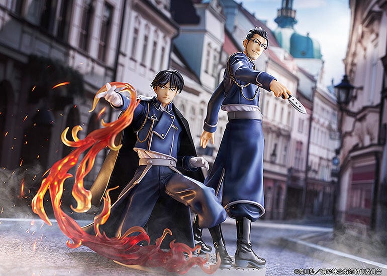 Fullmetal Alchemist figures of Roy Mustang with fiery alchemy effects and Maes Hughes with a knife, both in detailed blue military uniforms, symbolizing their friendship and strength.