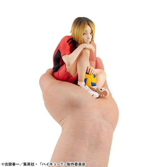Haikyu!! G.E.M. series figure of Kenma Kozume in a sitting pose, holding a volleyball, clad in Nekoma High's red jersey, with a reflective expression, capturing the essence of his calm and strategic character from the series.