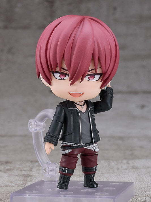 IDOLiSH7 Nendoroid Toma Inumaru figure featuring a black jacket, burgundy pants, and confident pose with interchangeable faceplates, set against a textured gray background.