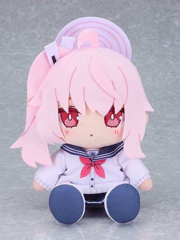 Blue Archive Natsu Plushie featuring pink hair, sailor-style uniform, and adorable red eyes, sitting in a cute pose.