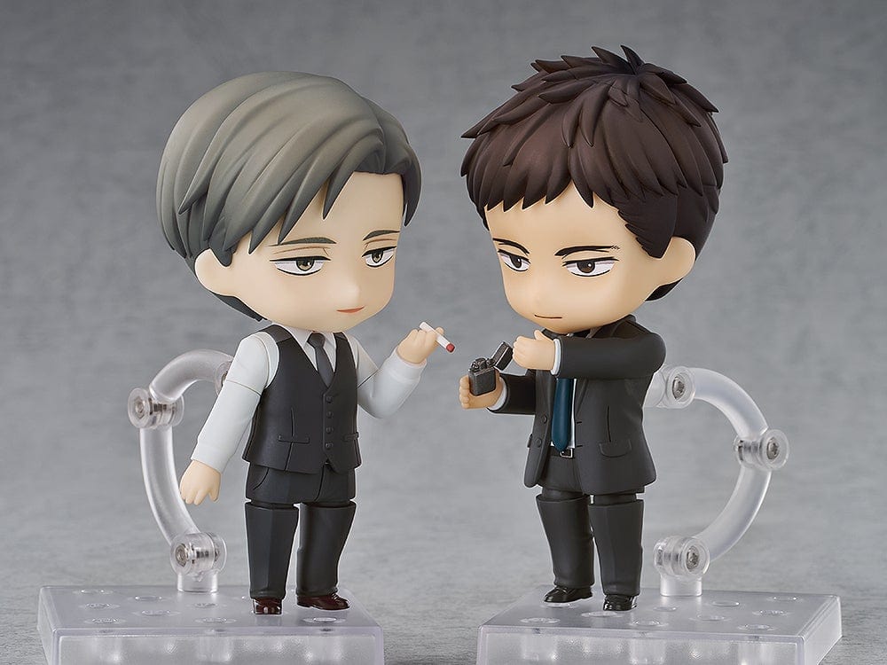 Twittering Birds Never Fly Nendoroid set featuring Yashiro and Chikara Domeki figures. Domeki holds an umbrella over Yashiro, both dressed in formal attire with a city background.