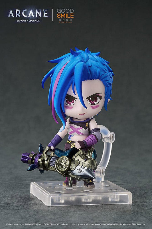 Nendoroid Jinx (Arcane Ver.) from League of Legends: Arcane, showcasing her iconic blue hair, purple outfit, and detailed weapon, posed with a confident grin.