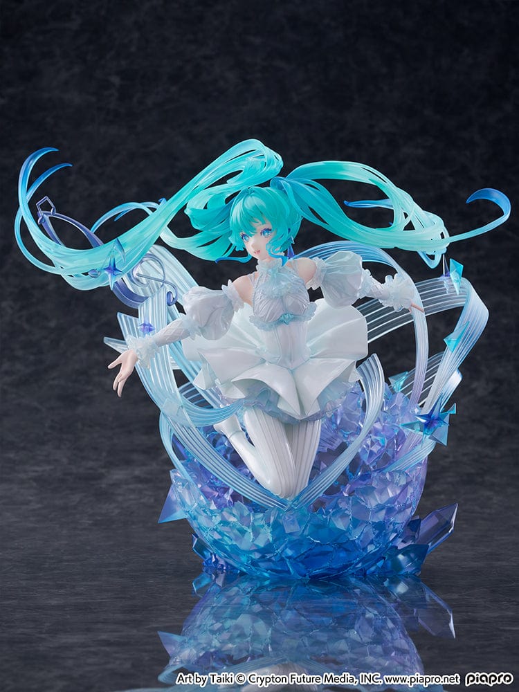 “Hatsune Miku (Crystal Dress Ver.) 1/7 scale figure—Miku in a white dress with translucent twin-tails, surrounded by swirling musical ribbons on a blue crystal base.”