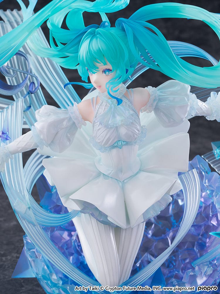 “Hatsune Miku (Crystal Dress Ver.) 1/7 scale figure—Miku in a white dress with translucent twin-tails, surrounded by swirling musical ribbons on a blue crystal base.”
