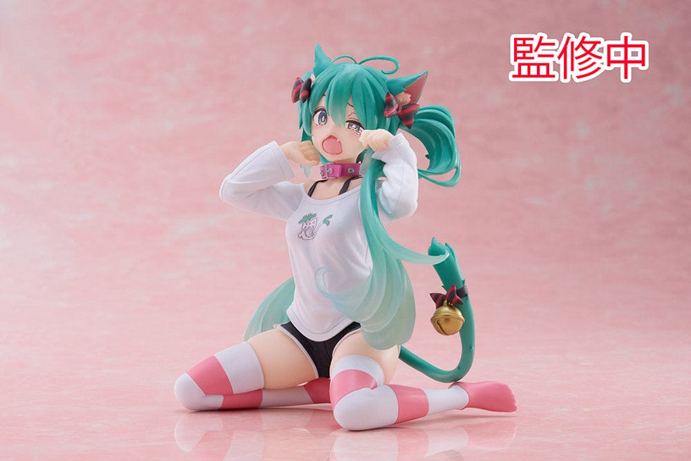 Hatsune Miku Desktop Cute Figure - Adorable and colorful figure of Hatsune Miku sitting playfully with a surprised expression, dressed in a casual leek-themed t-shirt and striped leg warmers, perfect for adding a touch of cuteness to any desk or shelf.