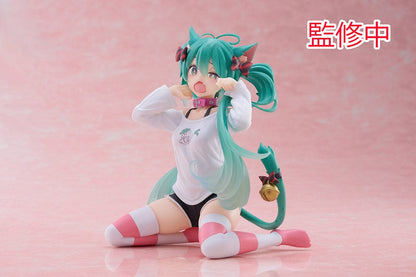 Hatsune Miku Desktop Cute Figure - Adorable and colorful figure of Hatsune Miku sitting playfully with a surprised expression, dressed in a casual leek-themed t-shirt and striped leg warmers, perfect for adding a touch of cuteness to any desk or shelf.