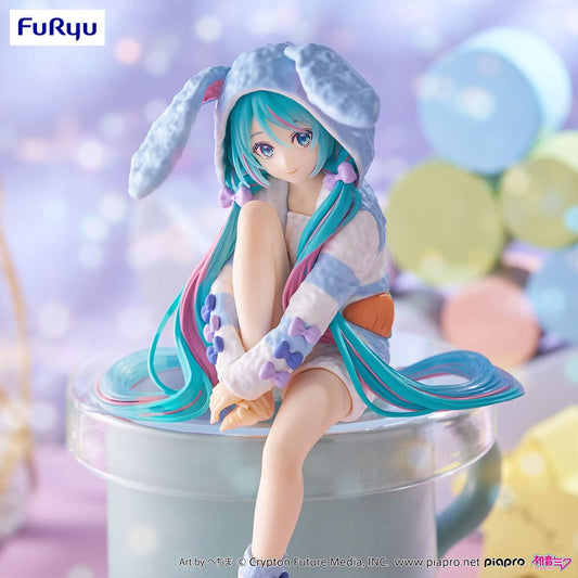 Vocaloid Hatsune Miku (Rabbit Ear Hood Pajama Blue Color Ver.) Noodle Stopper Figure – anime figure featuring Miku in a cozy bunny-ear hoodie with pastel blue and white colors, posed sitting with a soft expression.