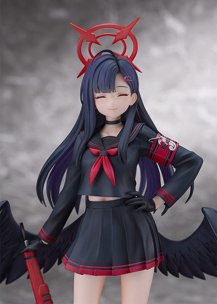 Blue Archive Ichika 1/7 scale figure in a dark school uniform with black wings, holding a red weapon and wearing a symbolic red halo-like accessory, with a calm, closed-eyed expression.